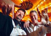 DAN FONTES (left) and Ed Cassel, both noted East Bay muralists, strike a pose inside the carnival Midway at Playland Not at the Beach, their latest mural project in El Cerrito, where the artists are helping recreate the glory days of Playland at the Beach in San Francisco. (SEAN CONNELLEY - Staff)